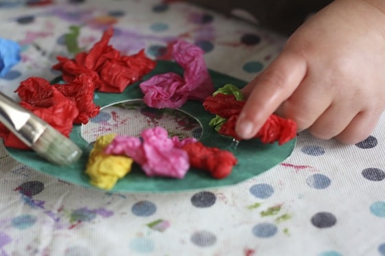 gluing tissue paper to cardboard wreath