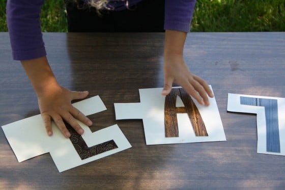 Child putting together pieces of homemade name puzzle