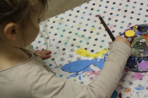 preschooler painting blue fish