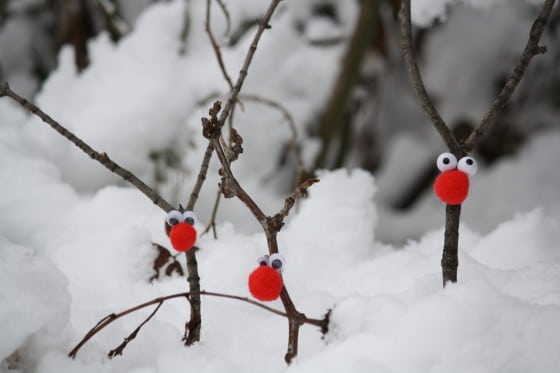 small twig reindeer decorations stuck into the snow