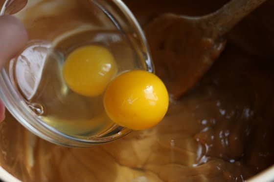 pouring eggs into cookie dough