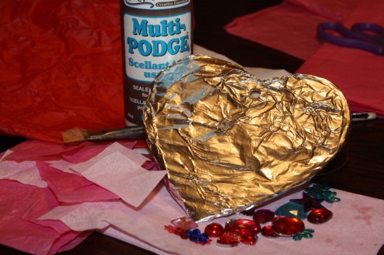 glue, cardboard heart covered with tin foil, craft gems, tissue paper