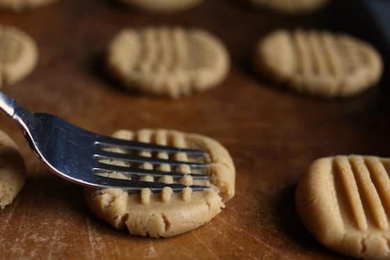 pressing peanut butter cookie dough with fork