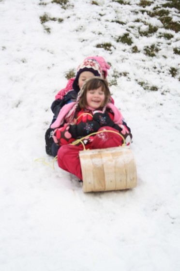 kids on wooden toboggan