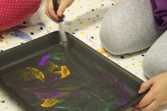 Kids painting styrofoam meat trays