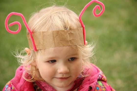 toddler wearing homeamde pink bug headband