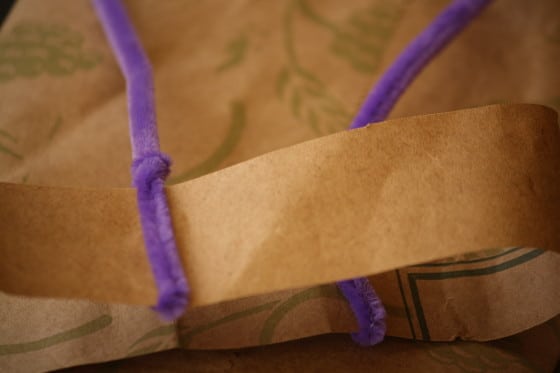 pipe cleaners wrapped around a paper bag strip