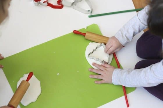 clay dough christmas tree, rolling pin on green cutting mat