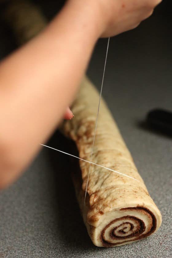 using dental floss to slice cinnamon roll dough into disks