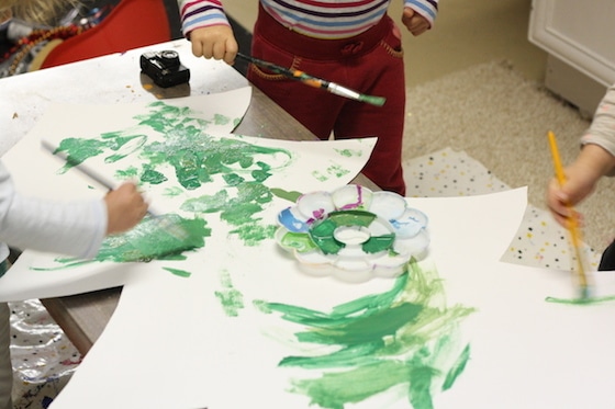 kids painting cardboard christmas tree