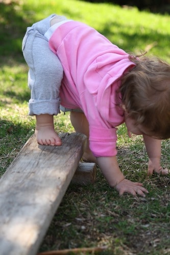 one year old on homemade balance beam