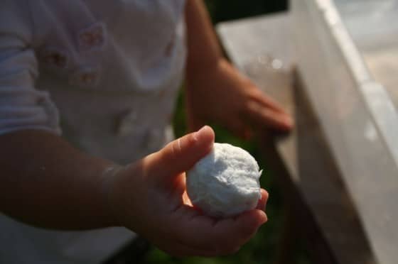 preschooler holding ball of ghost mud