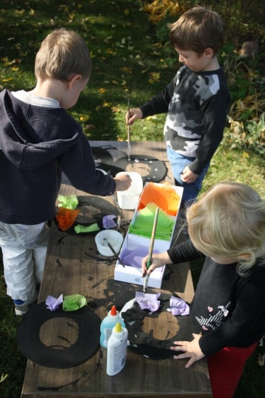 kids decorating halloween wreaths with tissue paper