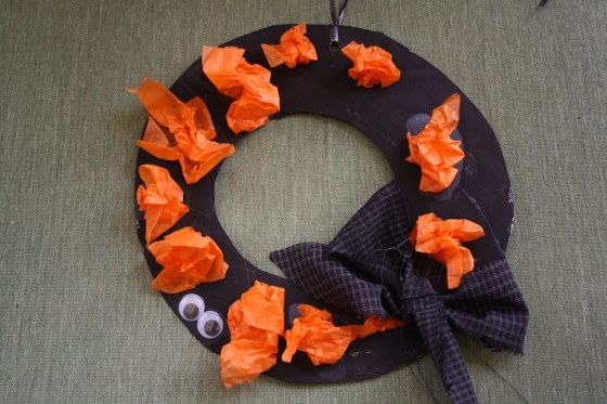 black halloween wreath with orange tissue paper