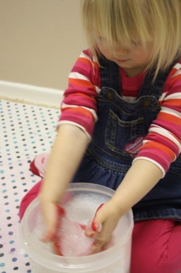 toddler washing paint off hands