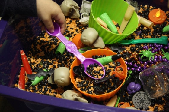 scooping beans in the halloween bin