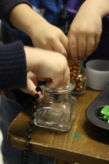 preschoolers sorting and transferring in a sensory bin