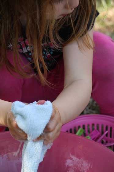 toddler wringing out facecloths