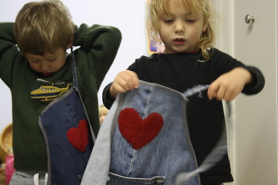 kids putting on repurposed denim aprons