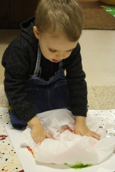 child smoosh painting with plastic bag