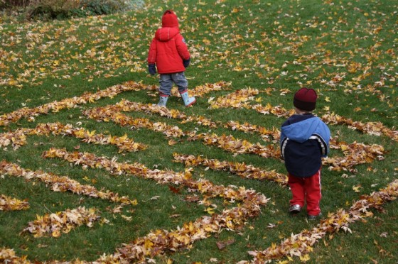 backyard leaf maze, toddler in red jacket, preschooler in blue jacket