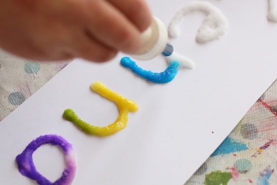 dripping watercolours onto letters traced with glue and salt