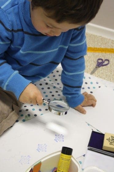 Preschooler using stamp and ink