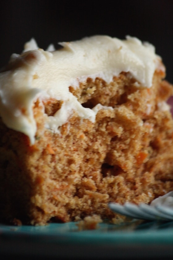 Close up carrot cake with Cream Cheese Frosting on blue plate with fork