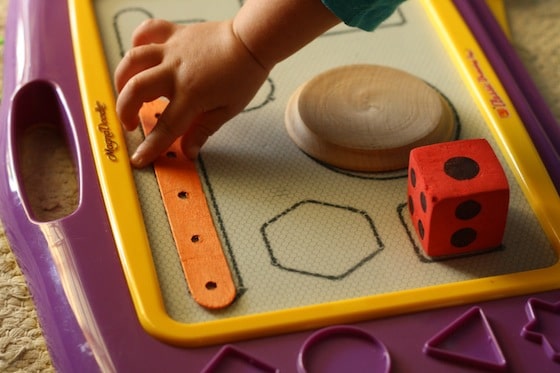 preschooler matching shapes drawn on magna doodle 