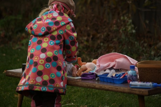 preschooler putting diaper on doll