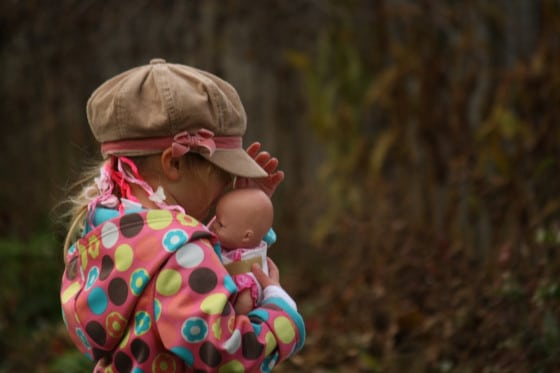 young girl holding doll