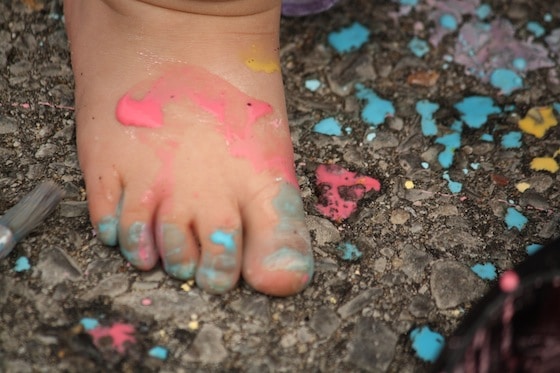 toddlers foot covered in chalk paint