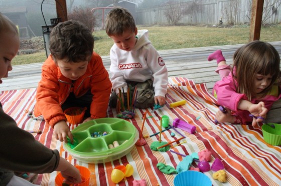 toddlers and preschoolers playing with rainbow play dough 