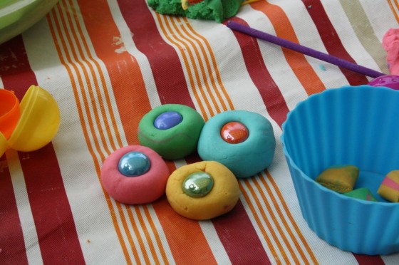 green yellow pink and blue play dough with beads