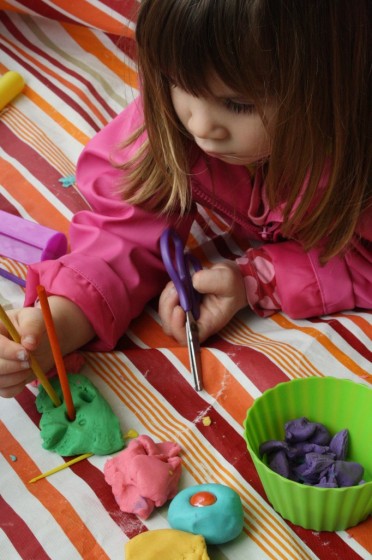 toddler poking homemade play dough with craft stick