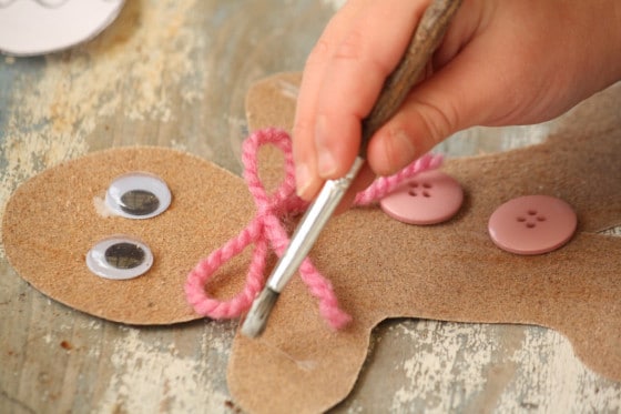 child decorating sandpaper gingerbread man