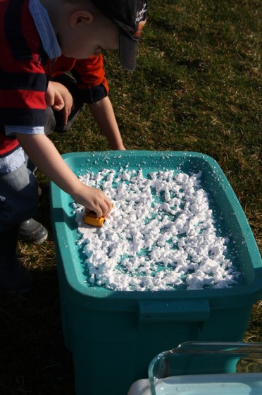 toddler driving toy car through shaving cream