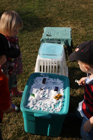 toddlers standing at pretend play car wash stations