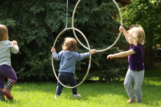 tossing balls through a hula hoop