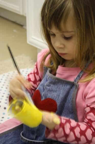 child painting toilet roll yellow