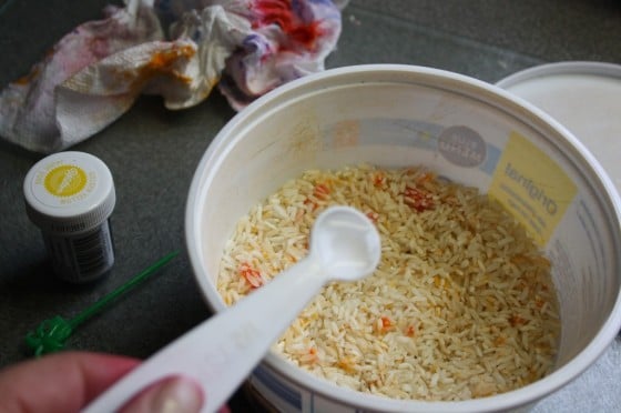 adding food colouring to rice for sensory play