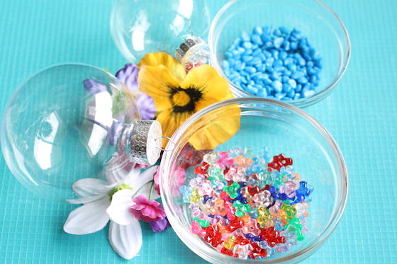 clear plastic ornament, artificial flowers, beads