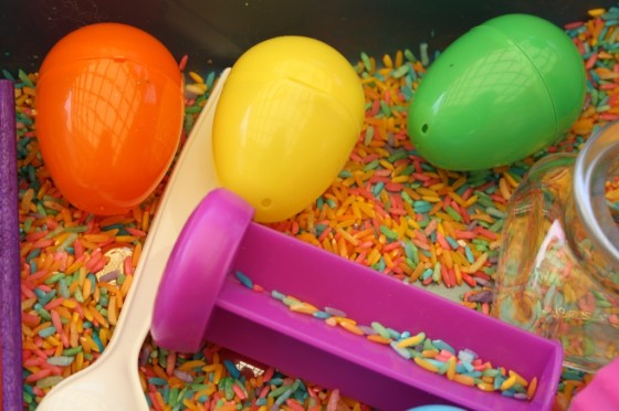 plastic eggs, spoon, dyed rice, jar