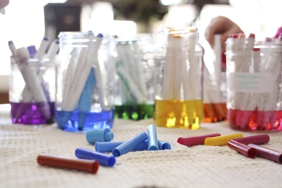 jars holding water and dried out markers 