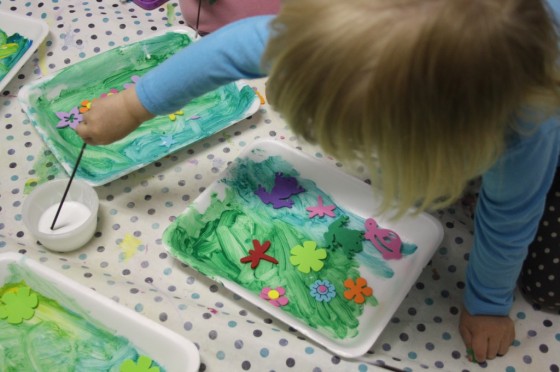 child painting styrofoam produce tray