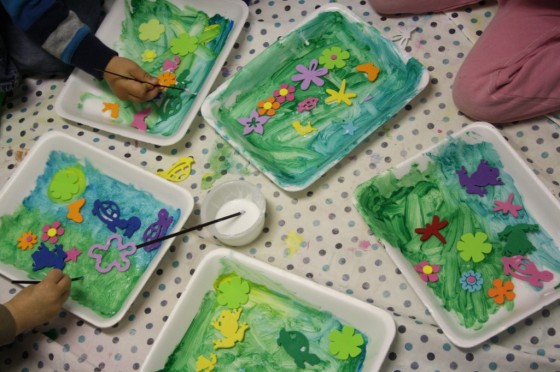 4 children painting styrofoam.