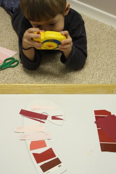 child photographing craft with toy camera