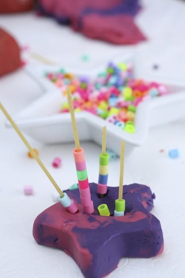 Uncooked Spaghetti with beads in play dough star