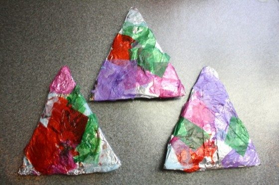 cardboard triangles covered with tin foil and tissue paper