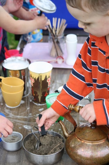 preschoolers scooping sand "sugar"